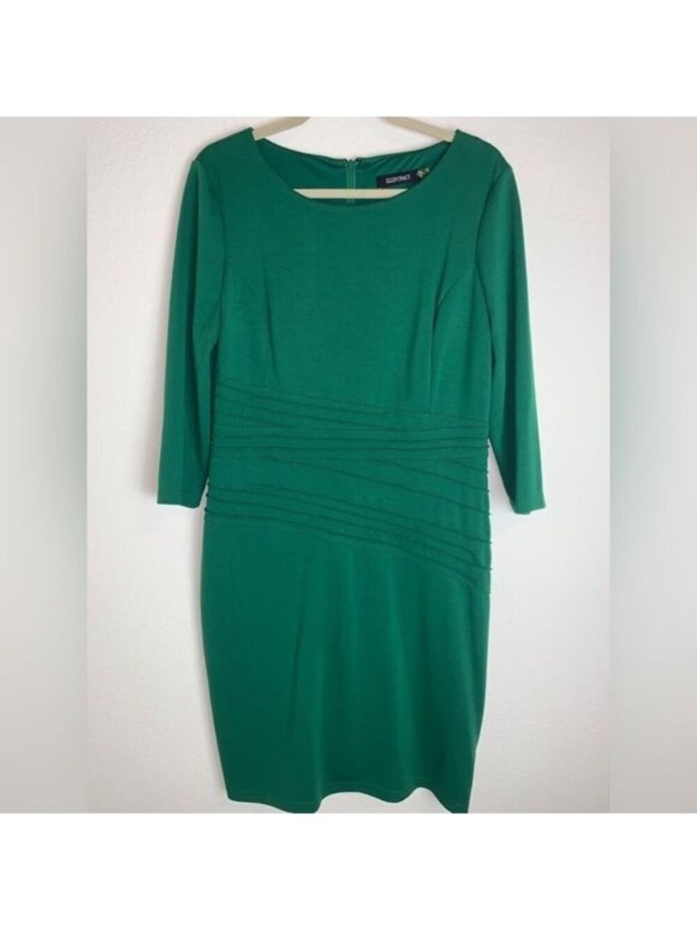 Ellen Tracey:  Dress adorned with intricate details around the waist